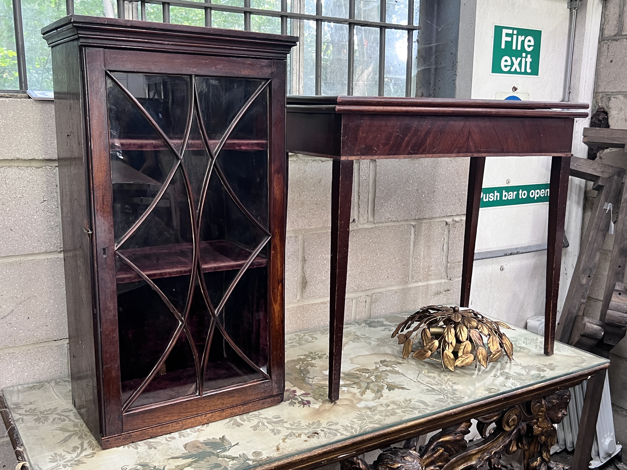 A small George III glazed mahogany hanging cupboard, height 85cm and a George III mahogany rectangular folding card table, width 80cm, depth 40cm, height 73cm (2)